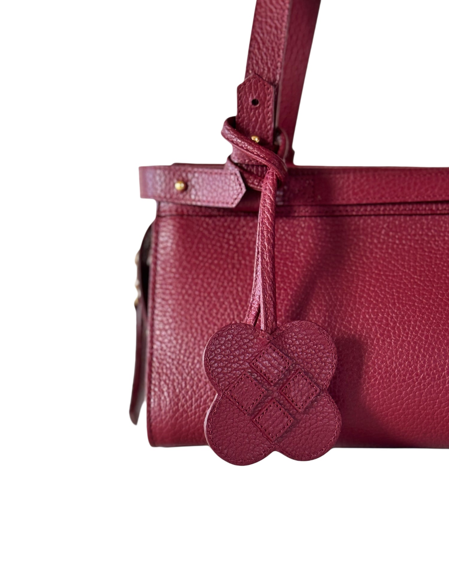 cranberry color scotch leather with a flower bag charm