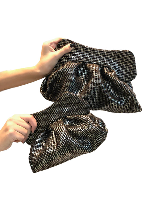 Black silver canvas bag held by a person on a white background