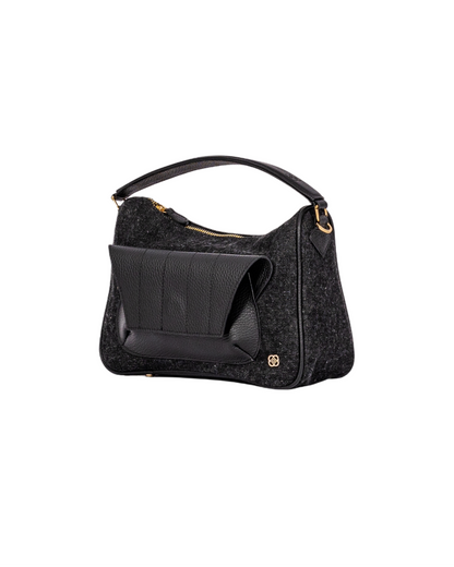 Black denim and leather cross body bag with top handle and outer front pocket and zipper pocket in the back. fits all your essentials for everyday casual look