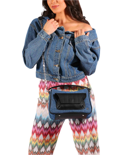 blue denim and black leather cross body bag with top handle and outer front pocket and zipper pocket in the back. fits all your essentials for everyday casual look