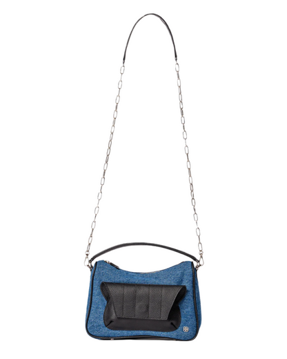 blue denim and black leather cross body bag with top handle and outer front pocket and zipper pocket in the back. fits all your essentials for everyday casual look